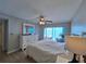 Bedroom with a ceiling fan, dresser, and a sliding glass door leading to an outdoor patio at 5404 Springwood Blvd # 5404, Pinellas Park, FL 33782
