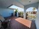 Outdoor patio with tiled flooring, a wrought iron gate and a view to the surrounding neighborhood at 5404 Springwood Blvd # 5404, Pinellas Park, FL 33782