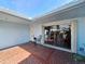 A tiled courtyard with sliding glass doors leading to the home's interior at 5404 Springwood Blvd # 5404, Pinellas Park, FL 33782