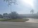 Long, one story home with a long, curved driveway, and palm trees at 5404 Springwood Blvd # 5404, Pinellas Park, FL 33782