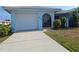 A single story home with a one car garage and a wrought iron gate that leads to a small courtyard at 5404 Springwood Blvd # 5404, Pinellas Park, FL 33782