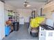 A residential garage space filled with storage and appliances at 5404 Springwood Blvd # 5404, Pinellas Park, FL 33782