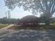 Charming red gazebo on a waterfront, accessible via a ramp, with a view of the tranquil pond at 5404 Springwood Blvd # 5404, Pinellas Park, FL 33782