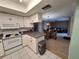 Spacious kitchen overlooking the dining area with white cabinets and modern appliances at 5404 Springwood Blvd # 5404, Pinellas Park, FL 33782