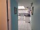 View into the kitchen featuring white cabinets, appliances, and tile flooring at 5404 Springwood Blvd # 5404, Pinellas Park, FL 33782