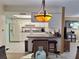 View of the kitchen featuring white cabinets, and a breakfast bar with seating at 5404 Springwood Blvd # 5404, Pinellas Park, FL 33782