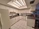 Well-lit kitchen with white cabinetry, modern appliances, and ample counter space at 5404 Springwood Blvd # 5404, Pinellas Park, FL 33782