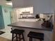 Close up of the kitchen featuring white cabinets, appliances, and a breakfast bar with seating at 5404 Springwood Blvd # 5404, Pinellas Park, FL 33782