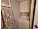 Small laundry area with stacked washer and dryer, including a towel rack at 5404 Springwood Blvd # 5404, Pinellas Park, FL 33782