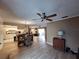 Open-concept living room with tiled floors, dining area, and updated kitchen in a cozy home at 5404 Springwood Blvd # 5404, Pinellas Park, FL 33782
