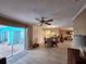 Inviting living room with wood-look flooring, neutral paint, and sliding glass doors to the outdoor patio at 5404 Springwood Blvd # 5404, Pinellas Park, FL 33782