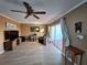 Open living room with wood flooring, neutral walls, and sliding glass doors at 5404 Springwood Blvd # 5404, Pinellas Park, FL 33782