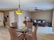 View of a living space showing dining table, chairs, wood floors, sofa, and neutral walls at 5404 Springwood Blvd # 5404, Pinellas Park, FL 33782