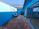 Charming outdoor patio with blue walls, a privacy screen, furniture, and unique tiled flooring at 5404 Springwood Blvd # 5404, Pinellas Park, FL 33782