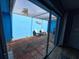 Outdoor patio featuring tiled flooring, seating and a bright blue accent wall at 5404 Springwood Blvd # 5404, Pinellas Park, FL 33782