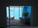A view of a sunny outdoor patio with a tiled floor, seating, and a bright blue wall at 5404 Springwood Blvd # 5404, Pinellas Park, FL 33782