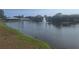 Picturesque pond featuring a fountain, creating a tranquil environment with grassy banks and views of community at 5404 Springwood Blvd # 5404, Pinellas Park, FL 33782