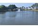 Scenic view of a serene pond with a fountain, surrounded by lush greenery and community buildings at 5404 Springwood Blvd # 5404, Pinellas Park, FL 33782