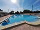 A swimming pool with a person in a float and lounge chairs around it at 5404 Springwood Blvd # 5404, Pinellas Park, FL 33782