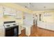 Bright eat-in kitchen featuring classic white cabinets, laminate countertops, and open floor plan at 5544 Caprice Way, Zephyrhills, FL 33541