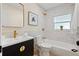 Well-lit bathroom with updated finishes, including marble tile, vanity with gold fixtures and shower at 5724 Dr Martin Luther King Jr N St, St Petersburg, FL 33703