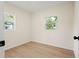 Room with wood floors, natural light from two windows, and neutral-colored walls at 5724 Dr Martin Luther King Jr N St # J, St Petersburg, FL 33703