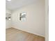 Empty room with light colored floors and two windows allowing for natural light at 5724 Dr Martin Luther King Jr N St, St Petersburg, FL 33703