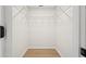 Walk-in closet featuring hardwood floors and wire shelving and bright white wall color at 5724 Dr Martin Luther King Jr N St, St Petersburg, FL 33703