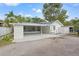 Well-maintained home featuring a spacious carport, a screened-in porch, and lush landscaping at 5724 Dr Martin Luther King Jr N St, St Petersburg, FL 33703