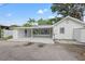 Well-maintained single-story house with a covered driveway and screened patio at 5724 Dr Martin Luther King Jr N St, St Petersburg, FL 33703