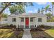 Charming home featuring a bright red front door and well-maintained landscaping at 5724 Dr Martin Luther King Jr N St # J, St Petersburg, FL 33703