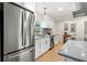 Well-lit kitchen with white cabinets, granite countertops, stainless steel appliances, and a modern design at 5724 Dr Martin Luther King Jr N St, St Petersburg, FL 33703