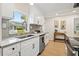 Modern kitchen featuring white cabinets, granite countertops, and stainless steel appliances with lots of natural light at 5724 Dr Martin Luther King Jr N St, St Petersburg, FL 33703