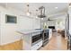 Open kitchen featuring a large island, stainless steel appliances, and an open concept layout to the living area at 5724 Dr Martin Luther King Jr N St, St Petersburg, FL 33703