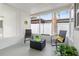 Relaxing screened-in porch with comfortable seating, plants, and a 'Home Sweet Home' sign at 5724 Dr Martin Luther King Jr N St, St Petersburg, FL 33703