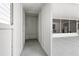 Enclosed storage area with gray flooring, white walls, and a view to the outside patio at 5724 Dr Martin Luther King Jr N St, St Petersburg, FL 33703