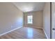 Bedroom with wood flooring, neutral walls, and a bright window for natural light at 6782 Breezy Palm Dr, Riverview, FL 33578