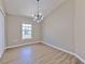 Bedroom with wood flooring, a modern light fixture, and a bright window at 6782 Breezy Palm Dr, Riverview, FL 33578