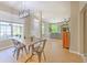 Inviting dining room with modern light fixture and table, next to living room and with big windows at 6782 Breezy Palm Dr, Riverview, FL 33578