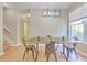 Bright dining room features modern lighting, wood flooring, and a spacious setting at 6782 Breezy Palm Dr, Riverview, FL 33578