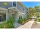 Charming home exterior with a covered entry, well-manicured shrubs, and a sidewalk leading to the front door at 6782 Breezy Palm Dr, Riverview, FL 33578