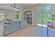 Comfortable living room with wood floors, large windows, and a sliding door leading to a backyard view at 6782 Breezy Palm Dr, Riverview, FL 33578