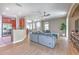 Open-concept living space with a large sofa, wood flooring, adjacent to the dining area and kitchen at 6782 Breezy Palm Dr, Riverview, FL 33578