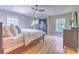 Spacious main bedroom with wood flooring, large windows, and neutral colors at 6782 Breezy Palm Dr, Riverview, FL 33578