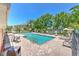 Community pool with lounge chairs, tables, and a serene lakeside view, perfect for relaxation at 6782 Breezy Palm Dr, Riverview, FL 33578