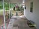 Back patio extends from the house with an exterior window at 7224 Ryman Loop, Zephyrhills, FL 33540