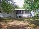 View of the backyard with patio and screened porch on the home at 7224 Ryman Loop, Zephyrhills, FL 33540