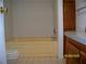 Bathroom features a tub with wood vanity and tile flooring at 7224 Ryman Loop, Zephyrhills, FL 33540