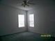 Bedroom with dual windows providing natural light and a ceiling fan at 7224 Ryman Loop, Zephyrhills, FL 33540