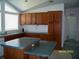 Functional kitchen with wood cabinets, an island, standard appliances, and lots of counter space at 7224 Ryman Loop, Zephyrhills, FL 33540